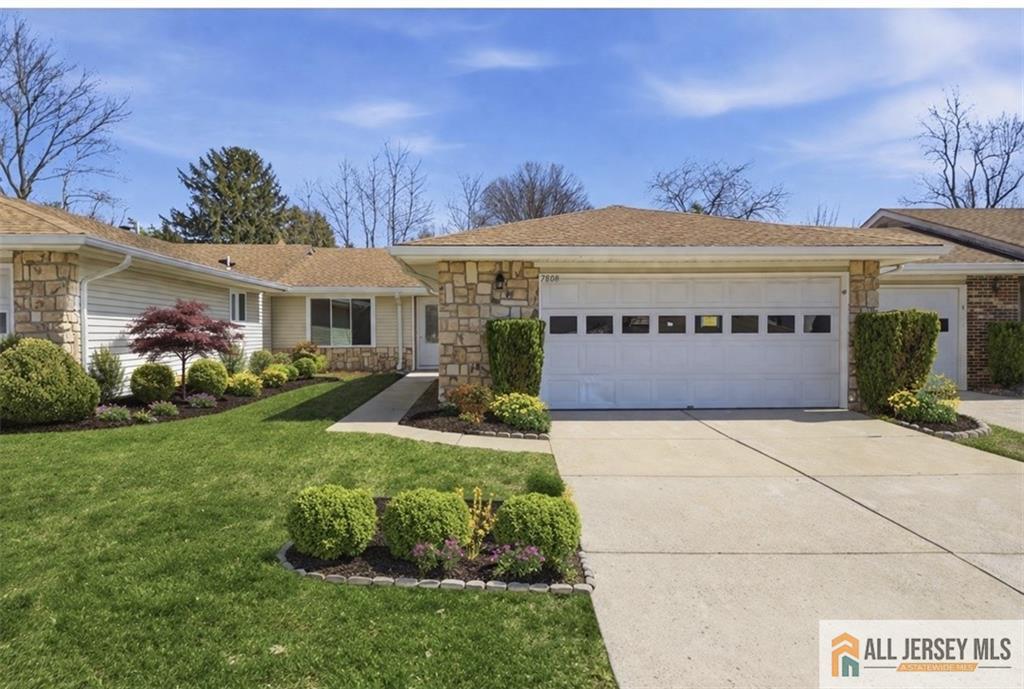 a view of a house with garden and a tree