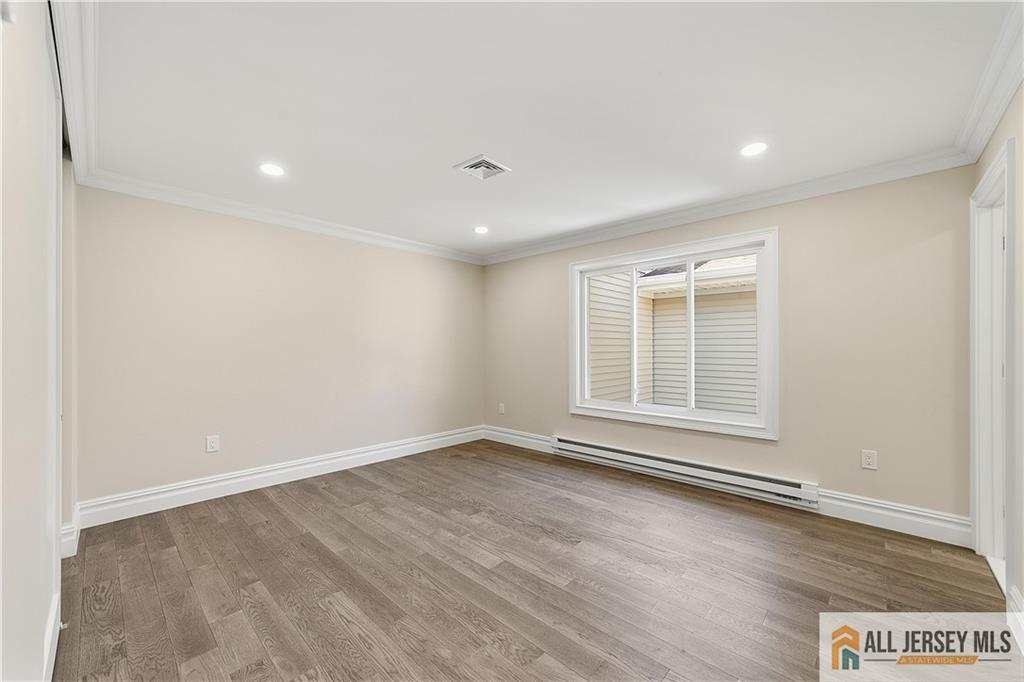 780 Ardmore Road, Unit 780B Monroe Township, NJ 08831 - Photo 15 of 30 an empty room with wooden floor and windows