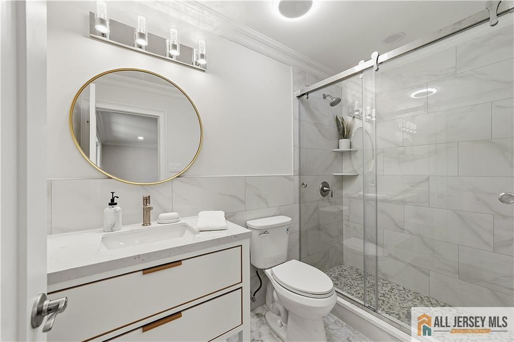 780 Ardmore Road, Unit 780B Monroe Township, NJ 08831 - Photo 17 of 30 a bathroom with a sink a toilet and a mirror