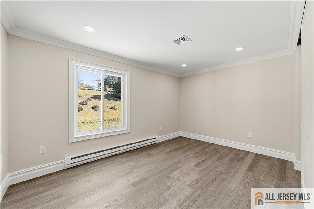 780 Ardmore Road, Unit 780B Monroe Township, NJ 08831 - Photo 18 of 30 an empty room with wooden floor and window