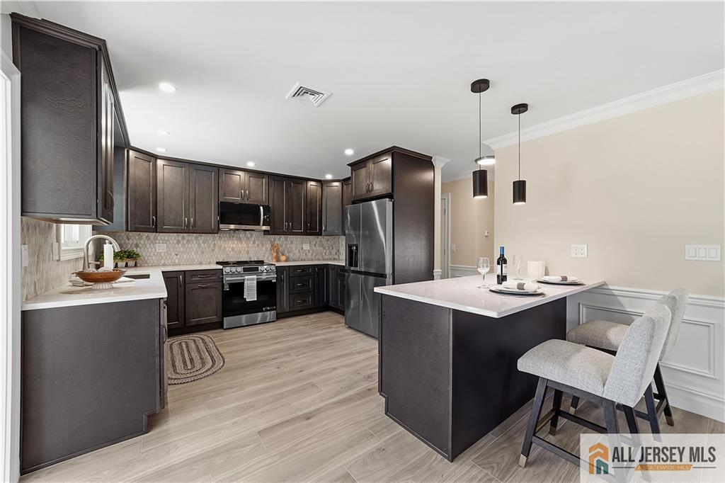780 Ardmore Road, Unit 780B Monroe Township, NJ 08831 - Photo 7 of 30 a kitchen with kitchen island stainless steel appliances a sink stove and refrigerator
