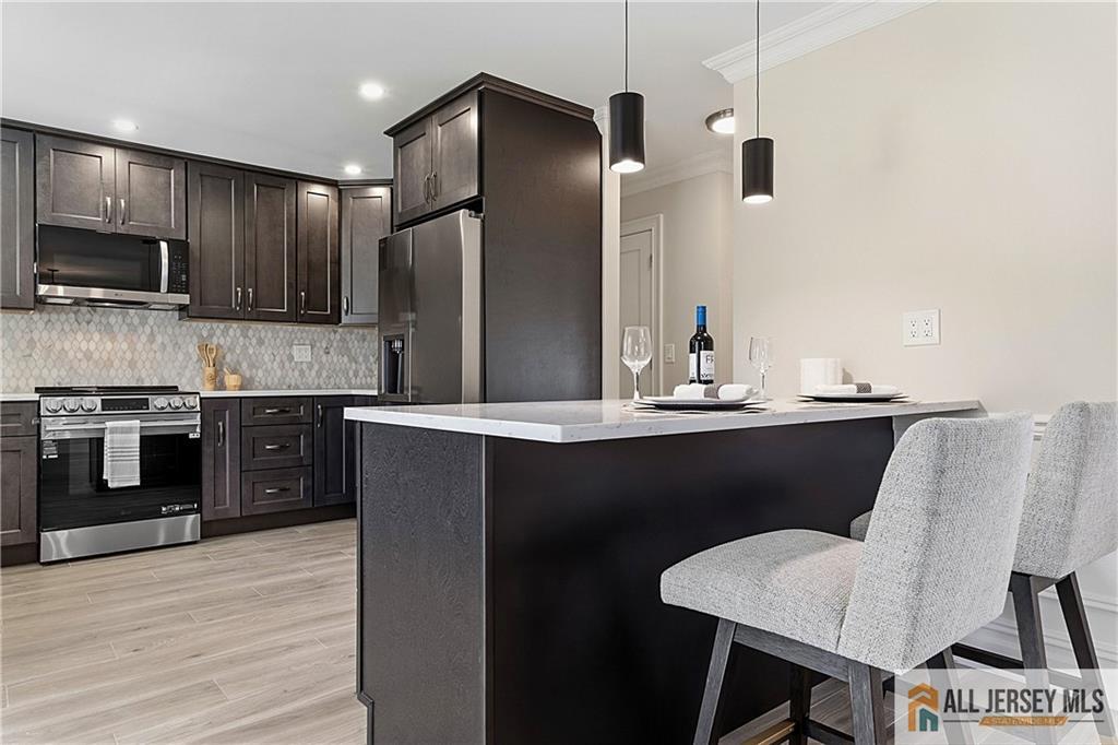 780 Ardmore Road, Unit 780B Monroe Township, NJ 08831 - Photo 8 of 30 a kitchen with kitchen island stainless steel appliances a sink stove and refrigerator