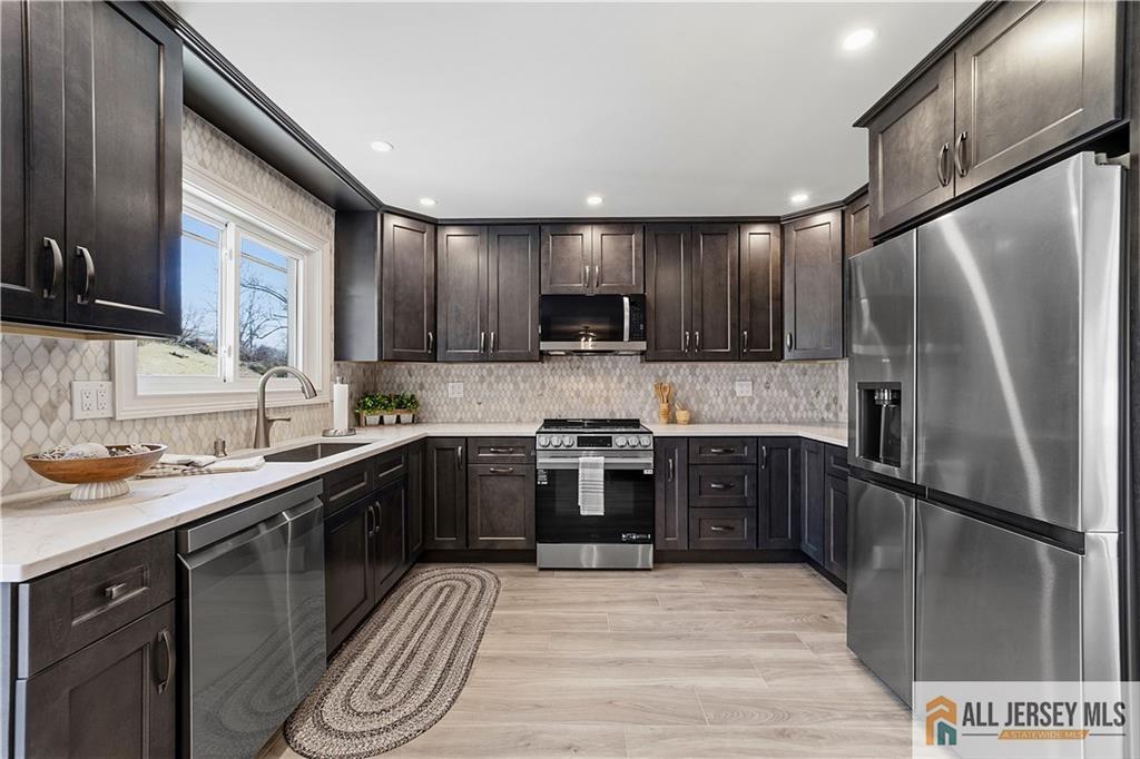 780 Ardmore Road, Unit 780B Monroe Township, NJ 08831 - Photo 9 of 30 a kitchen with stainless steel appliances granite countertop a sink stove and refrigerator
