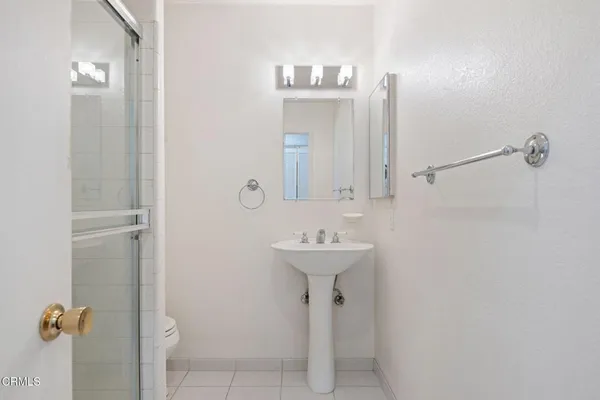 a bathroom with a sink a mirror and shower