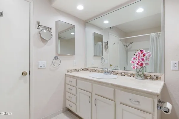 a bathroom with a sink vanity and mirror