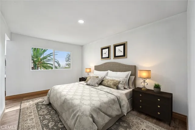 a bedroom with a bed and a painting on the wall