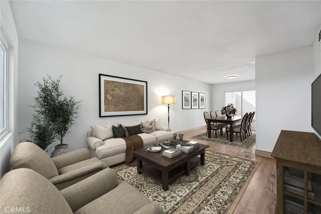 a living room with furniture potted plant and a lamp
