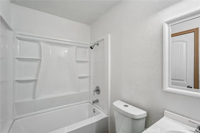 a bathroom with a toilet and a bathtub