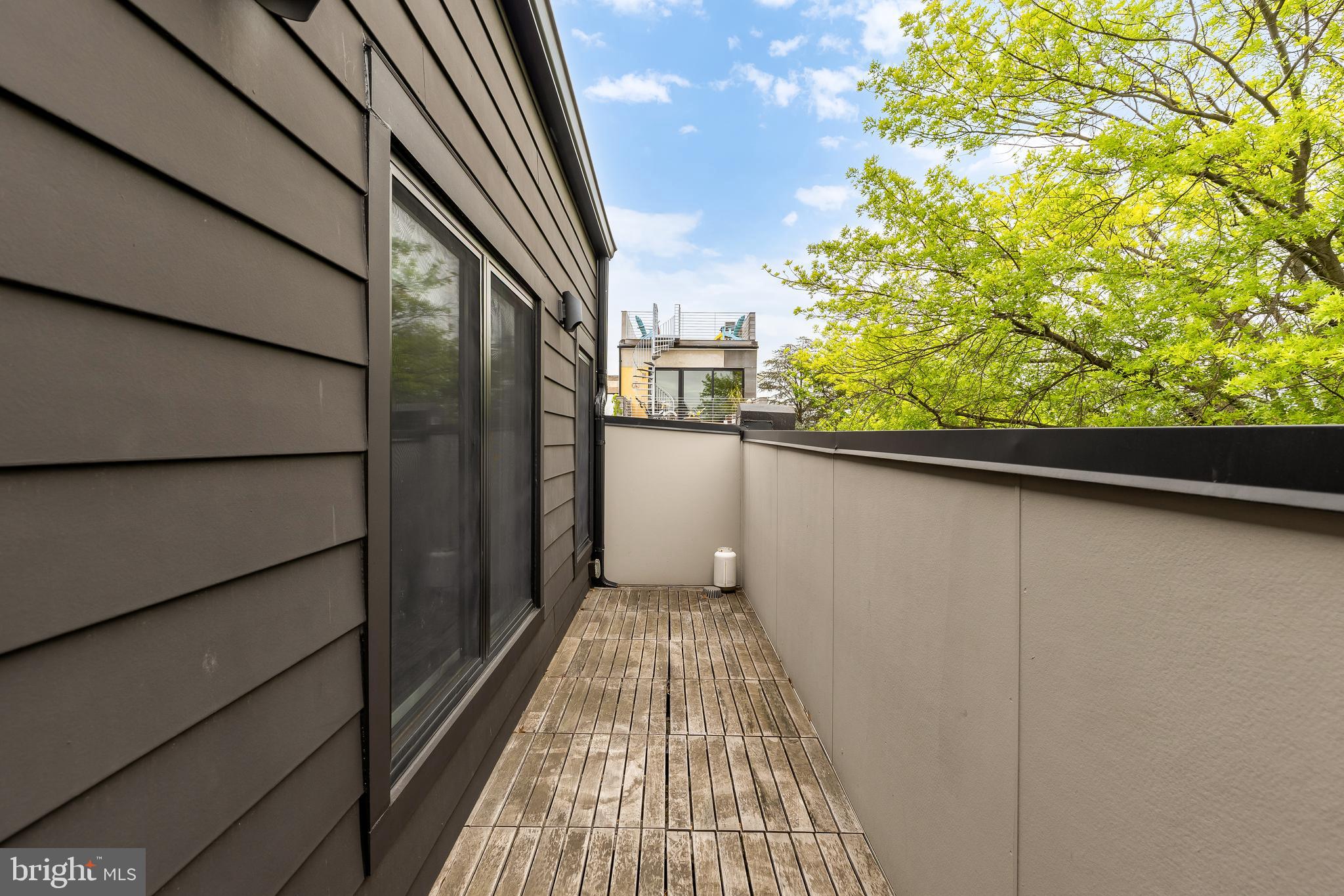 2534 11th Street Northwest, Unit 2 Washington, DC 20001 - Photo 24 of 50 a view of a balcony with wooden floor and fence