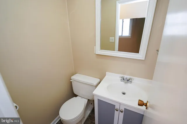 a white toilet sitting next to a bathroom sink