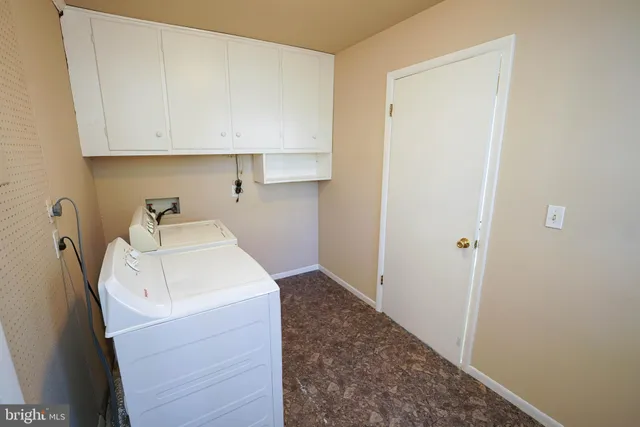 a utility room with a sink dryer and washer