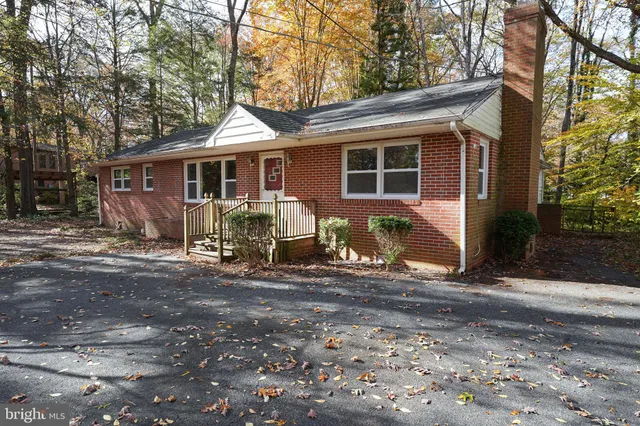 a view of a house with yard and sitting area