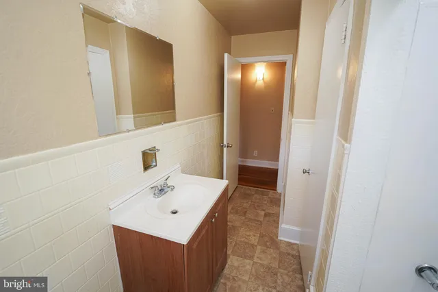 a bathroom with a sink a toilet and mirror