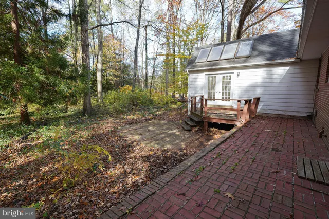 a view of backyard with table and chairs and wooden fence