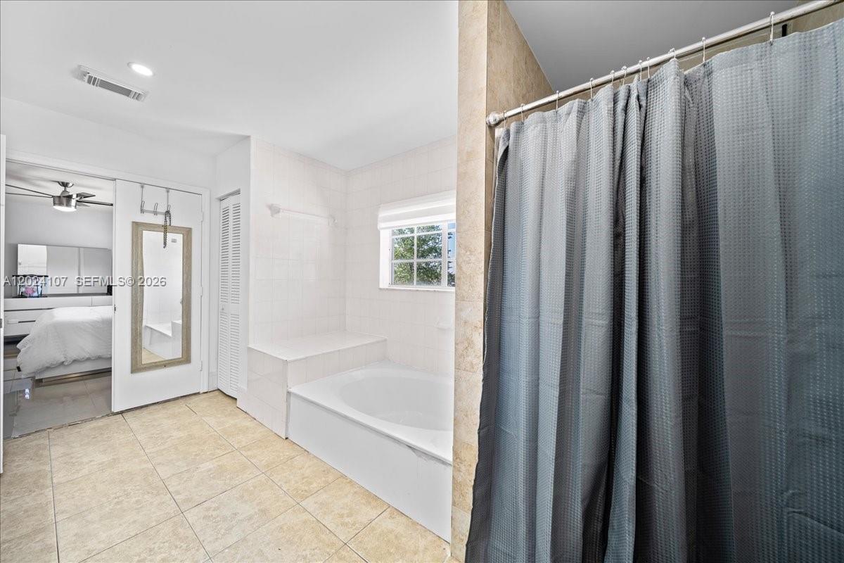 15341 Southwest 36th Street Miami, FL 33185 - Photo 40 of 56 a bathroom with a shower and a bath tub