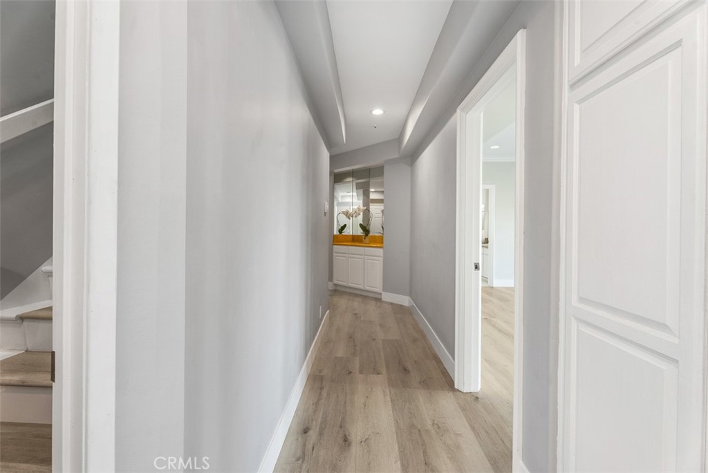 22 Cresta Del Sol San Clemente, CA 92673 - Photo 31 of 70 Downstairs, we have the remainer of the house with a laundry room, 4 Bedrooms, each with their own bathroom and doors to the exterior. Great for multi-generational living. Hallway has an abundance of closets and additional storage.