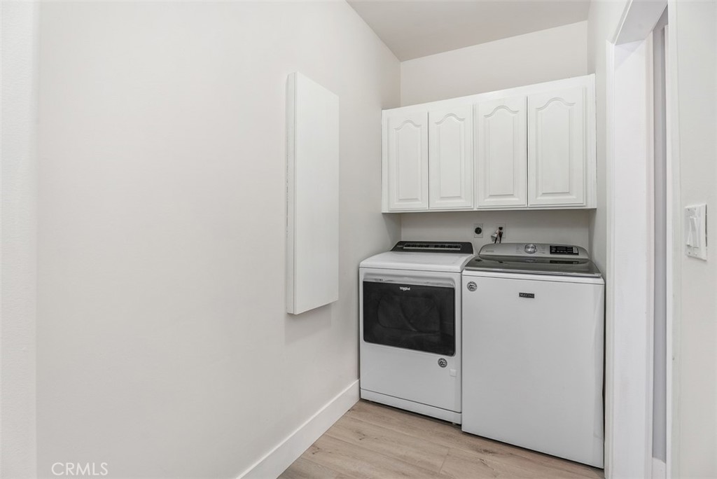 22 Cresta Del Sol San Clemente, CA 92673 - Photo 32 of 70 Downstairs laudry room with sink, ironing board, folding counter and linen storage.