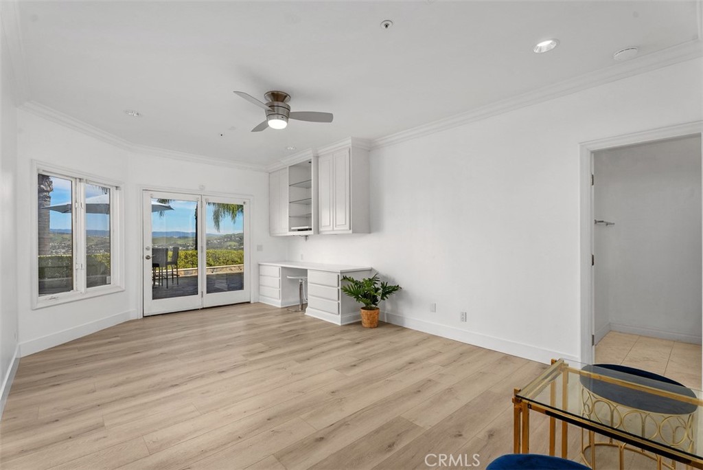 22 Cresta Del Sol San Clemente, CA 92673 - Photo 39 of 70 Third bedroom downstairs, it too has built-in desk with overhead cabinets, a walk-in closet with built-in drawers and it's own private bathroom. Again, all these bedrooms have their own access to the single level outdoor patio with amazing views.