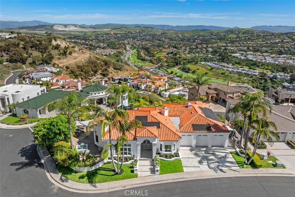 22 Cresta Del Sol San Clemente, CA 92673 - Photo 55 of 70 Front arial of house, solar panels, new tankless water heater, A/C, trey ceilings, recessed lighting throughout and much more. Street level of this house is all the living space, 3 car garage, laundry in garage, with 4 bedrooms and bathrooms and laundry room downstairs.