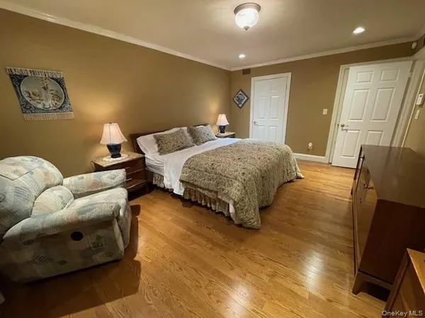 a bedroom with double bed and a couch