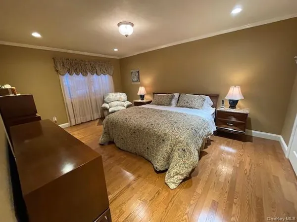 a bedroom with a bed and a mirror