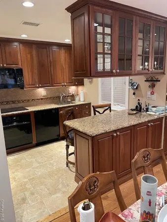 a kitchen with a sink and a stove top oven