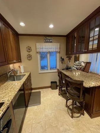 a kitchen with a stove a sink and a refrigerator