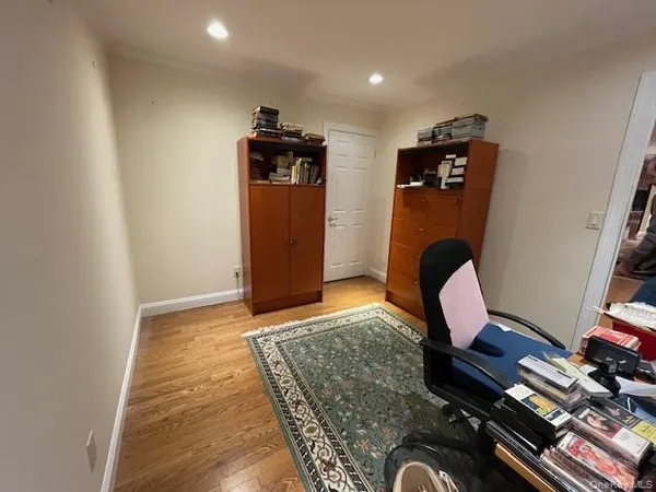 a view of workspace with wooden floor windows and wardrobe