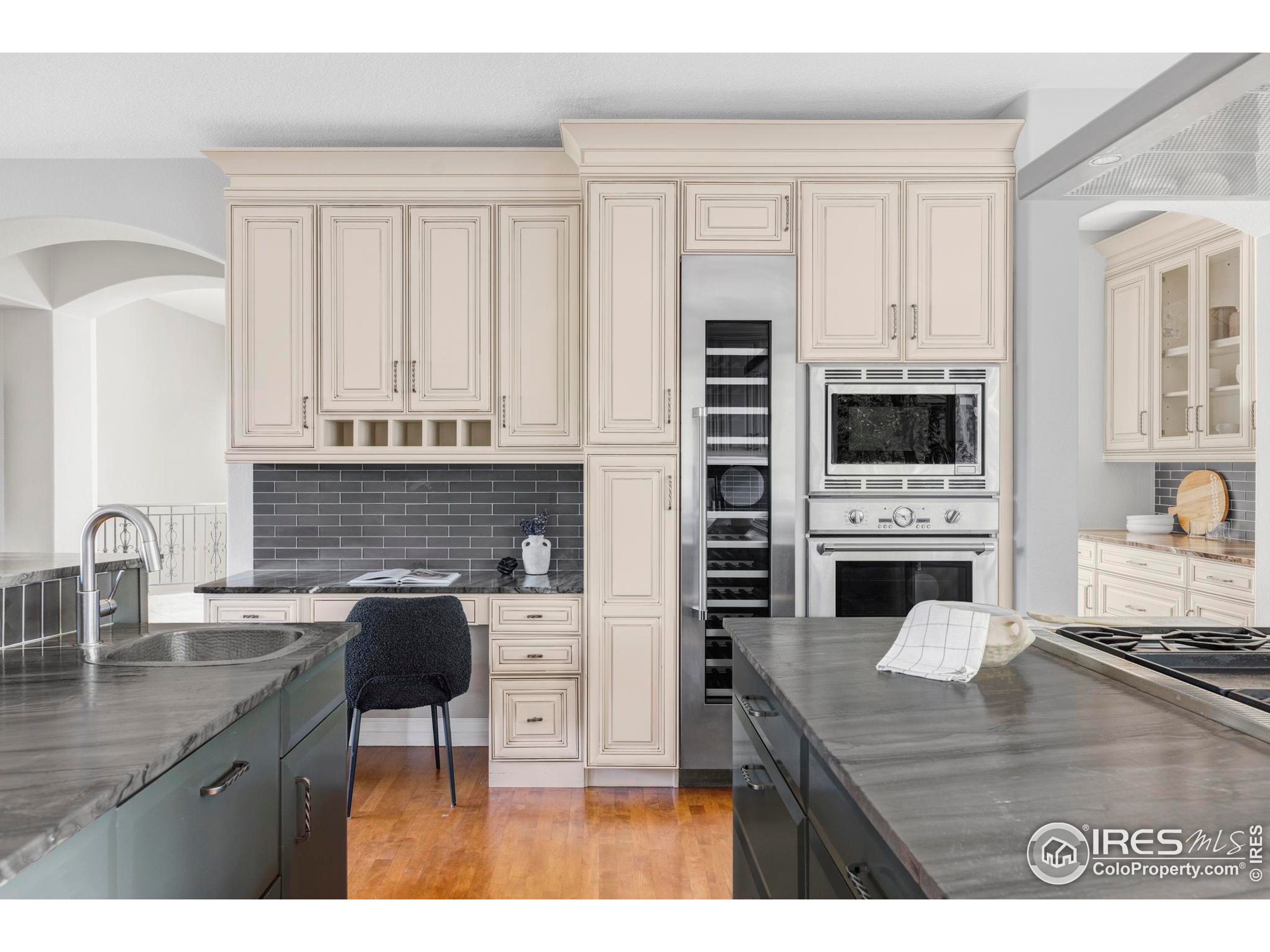 9022 Jason Court Boulder, CO 80303 - Photo 14 of 36 a kitchen with granite countertop a stove a sink and a microwave