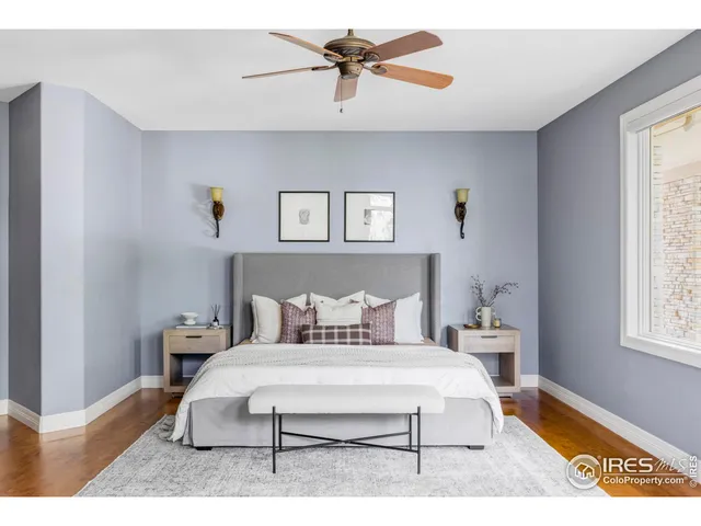 a bedroom with a bed a window and chandelier