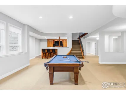 a room with pool table and windows
