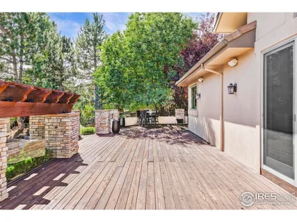 a view of balcony with wooden floor and outdoor seating