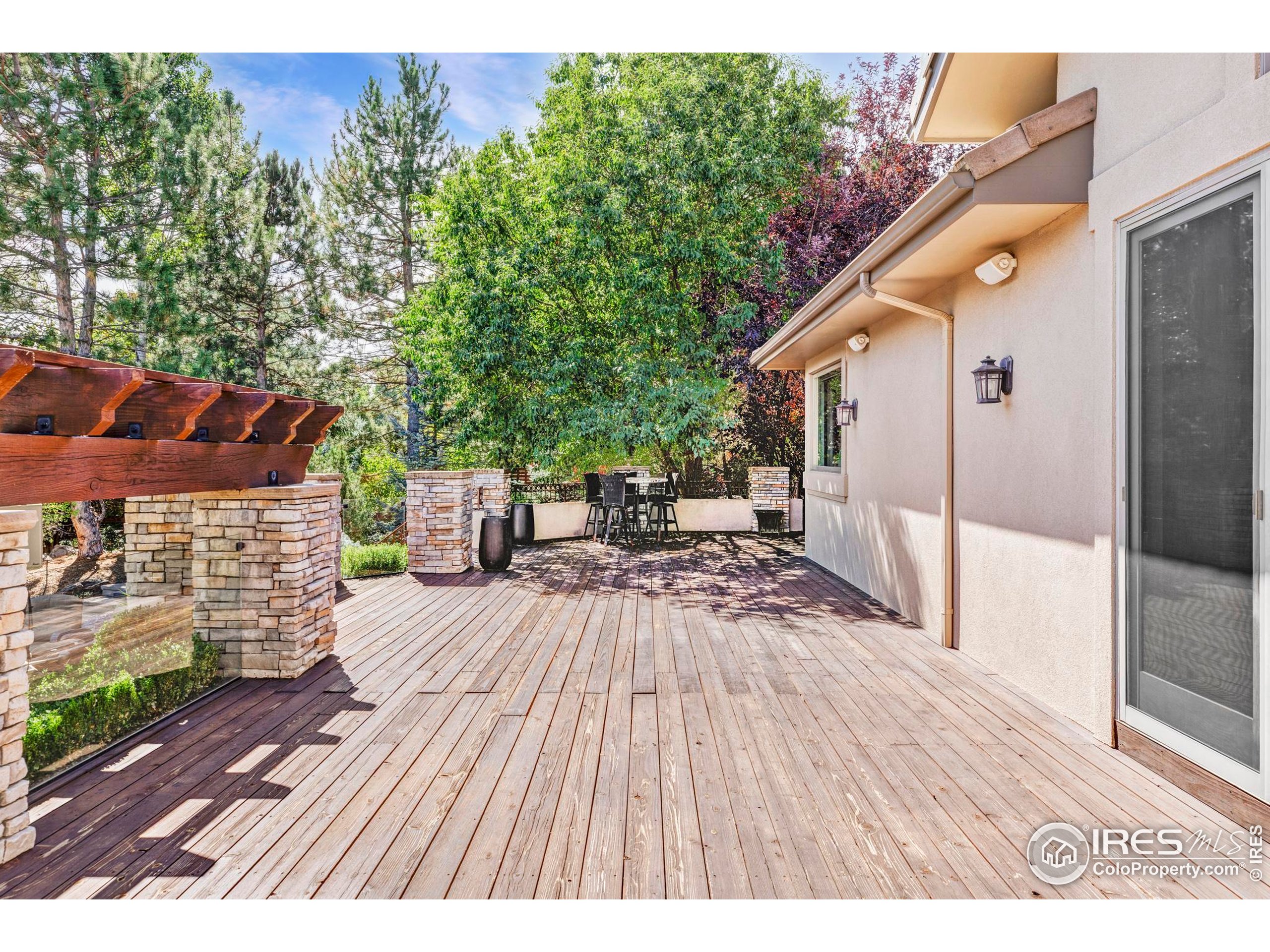 9022 Jason Court Boulder, CO 80303 - Photo 29 of 36 a view of balcony with wooden floor and outdoor seating