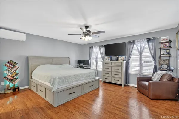 a bedroom with furniture and a flat screen tv