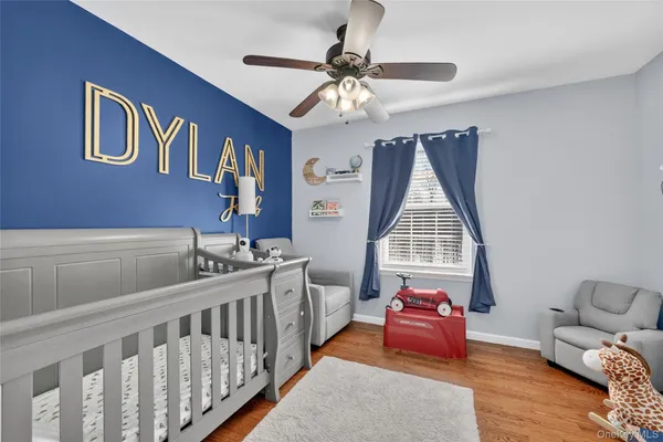 a bedroom with furniture and a large window