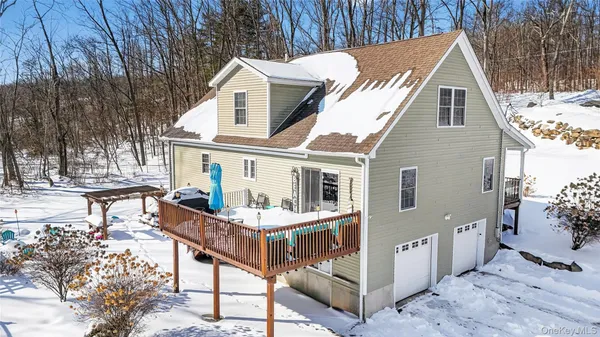 a view of a house with backyard and sitting area