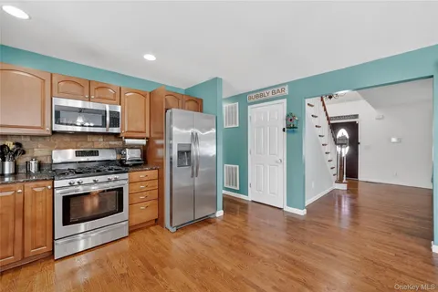 a kitchen with stainless steel appliances a refrigerator and a stove top oven