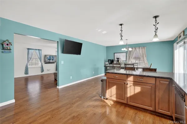a view of a kitchen with wooden floor