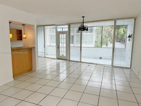 a kitchen with granite countertop white cabinets and sink
