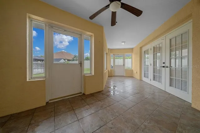 a front view of a house with garden and trees