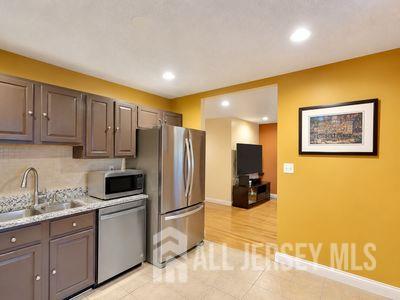 31 Edinburgh Court Edison, NJ 08820 - Photo 10 of 25 a kitchen with a refrigerator and cabinets