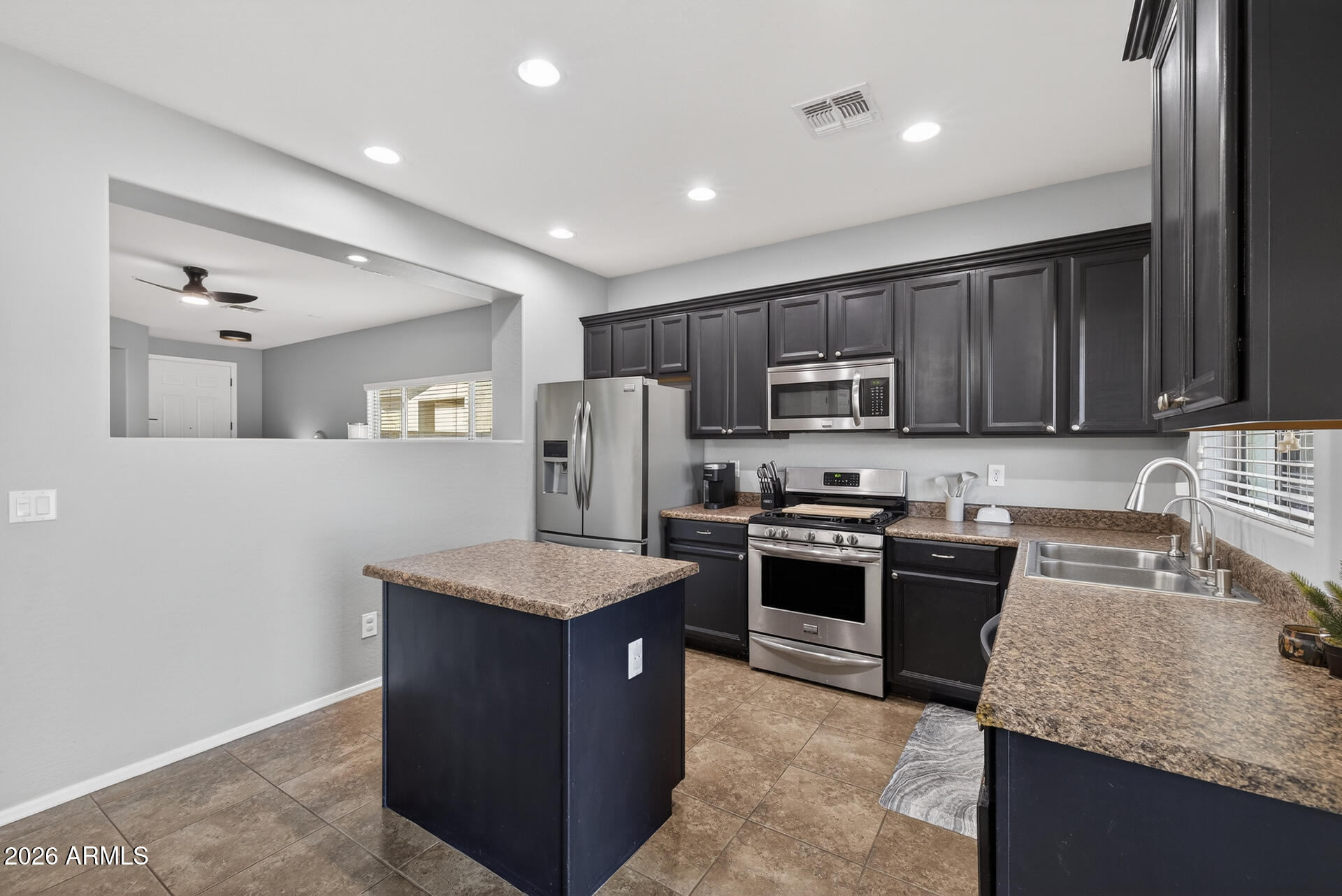 724 West Trellis Road Queen Creek, AZ 85140 - Photo 12 of 46 a kitchen with stainless steel appliances granite countertop a stove top oven a sink and dishwasher