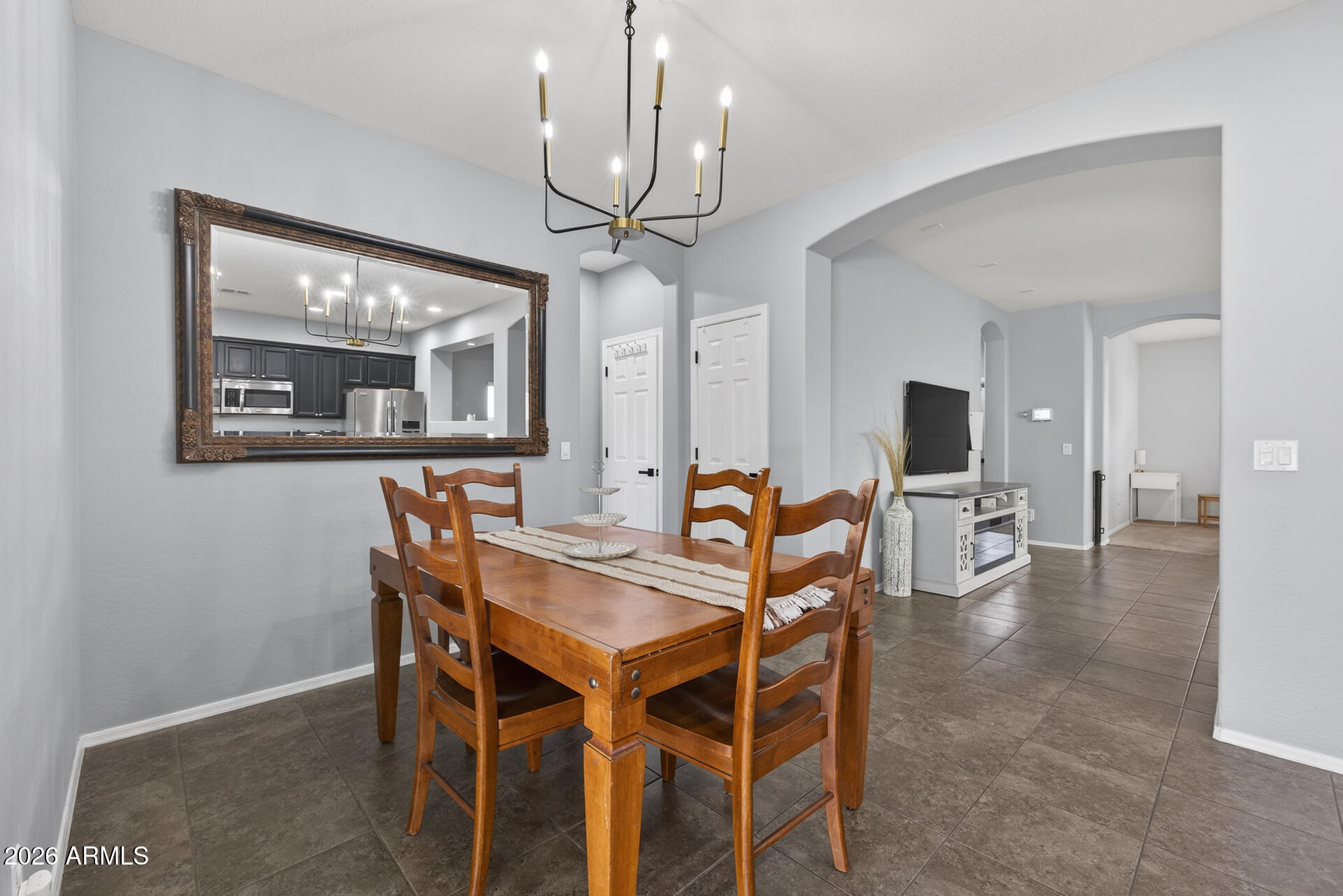 724 West Trellis Road Queen Creek, AZ 85140 - Photo 15 of 46 a view of a dining room with furniture and a chandelier
