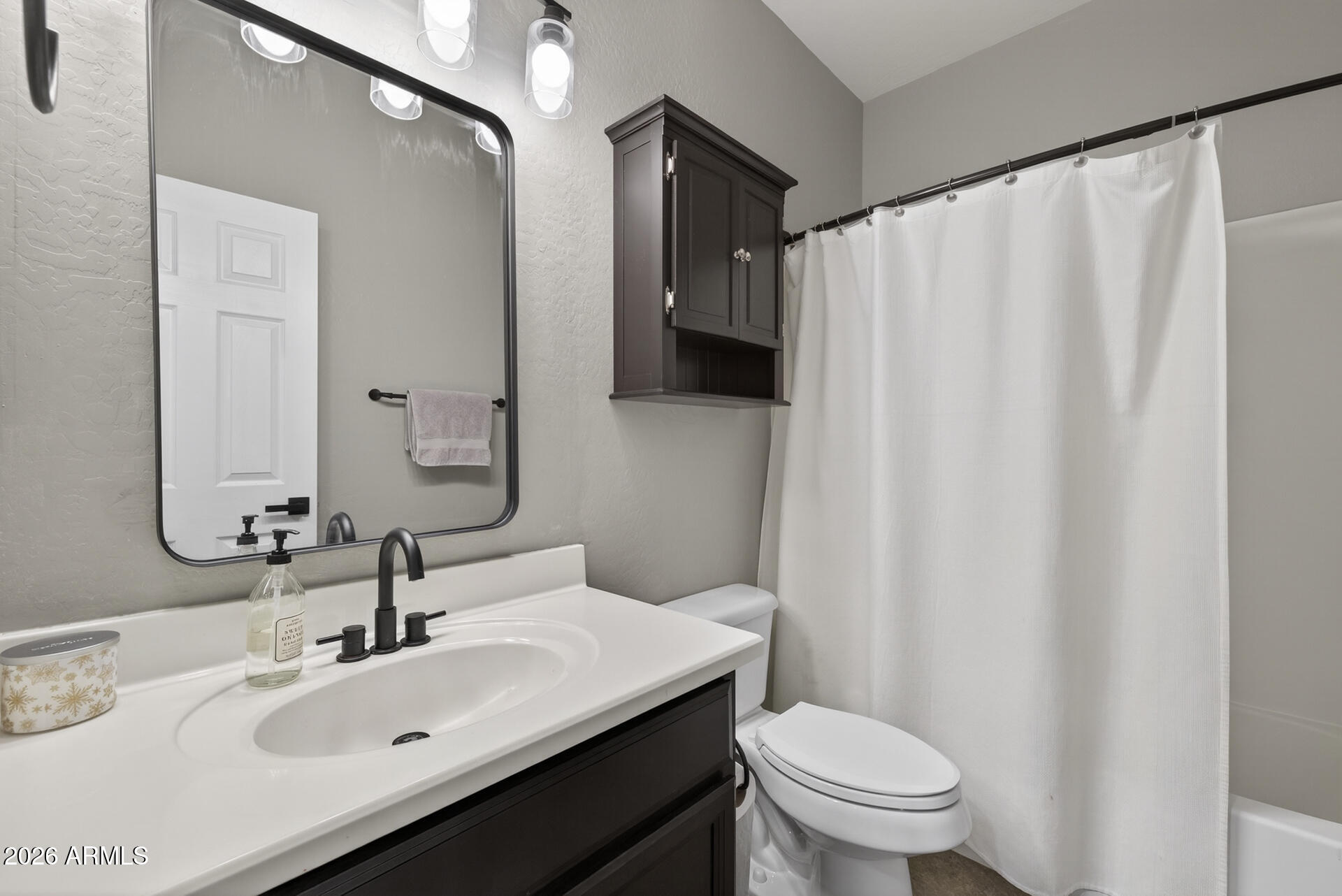 724 West Trellis Road Queen Creek, AZ 85140 - Photo 21 of 46 a bathroom with a sink a toilet and shower curtain