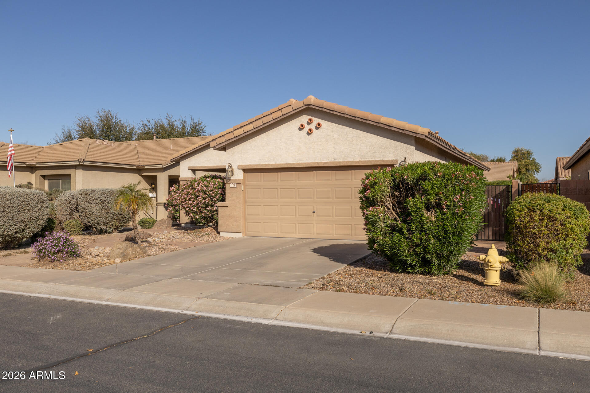 724 West Trellis Road Queen Creek, AZ 85140 - Photo 4 of 46 a front view of a house with a yard and garage