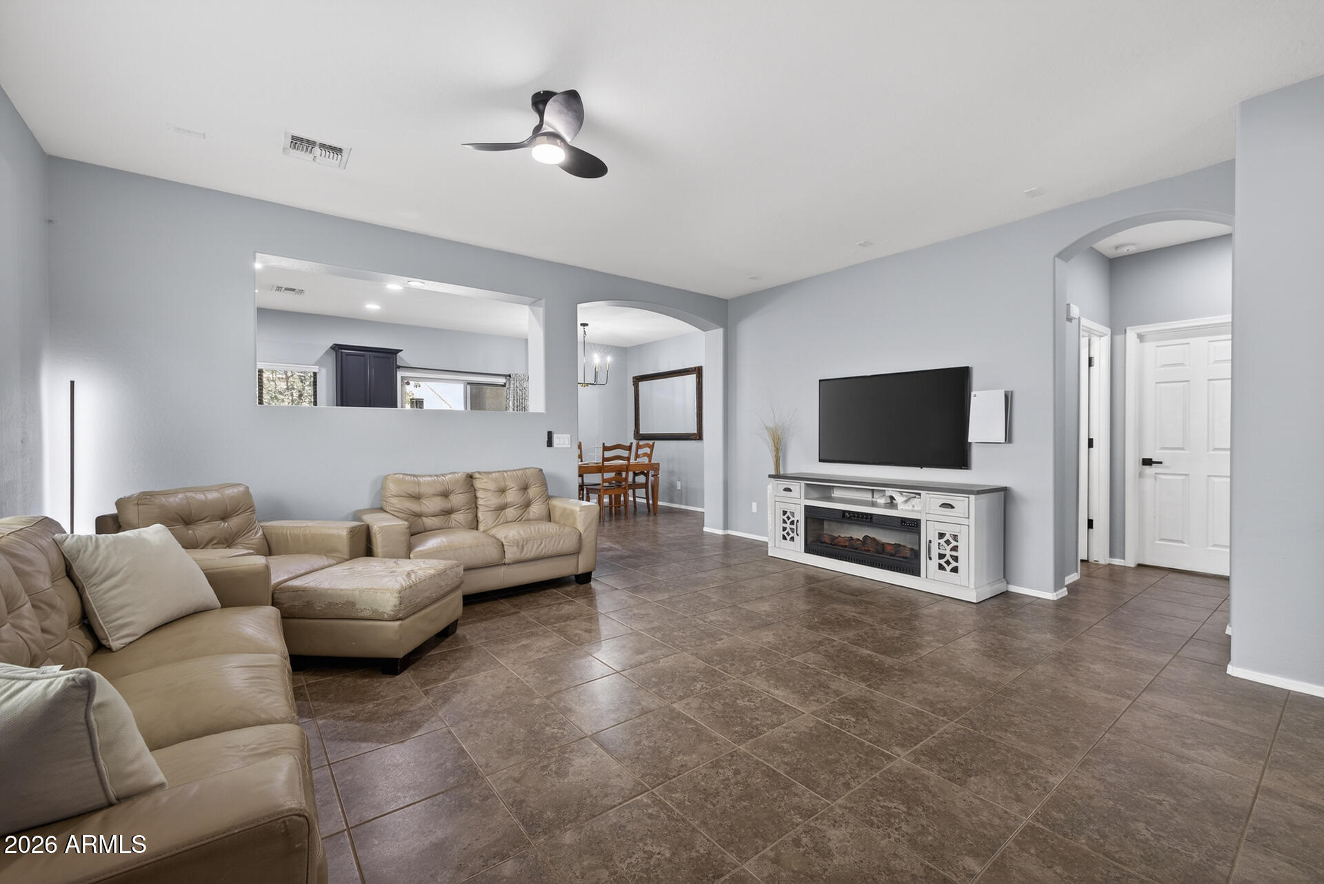 724 West Trellis Road Queen Creek, AZ 85140 - Photo 5 of 46 a living room with furniture and a flat screen tv