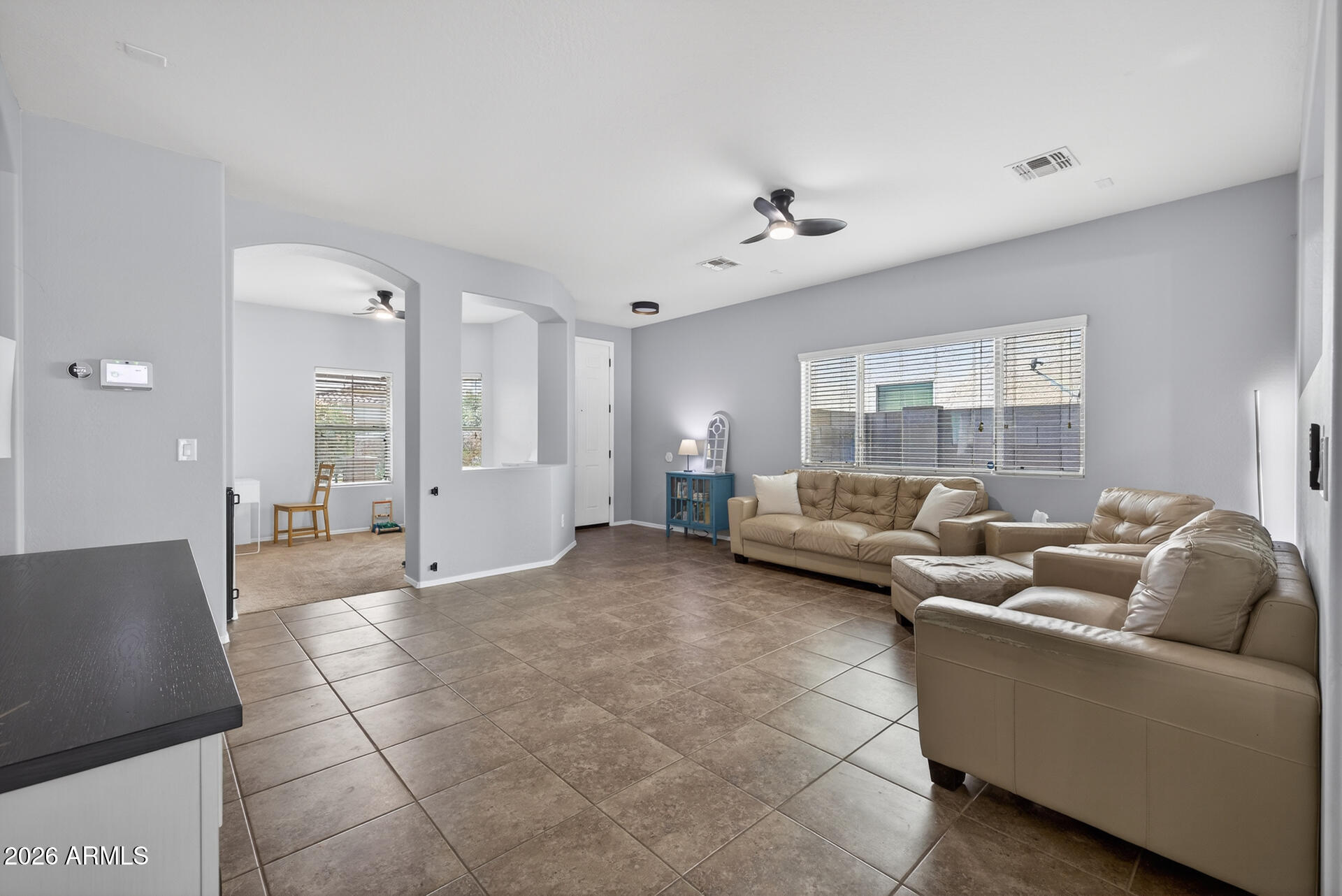 724 West Trellis Road Queen Creek, AZ 85140 - Photo 7 of 46 a living room with furniture and a chandelier