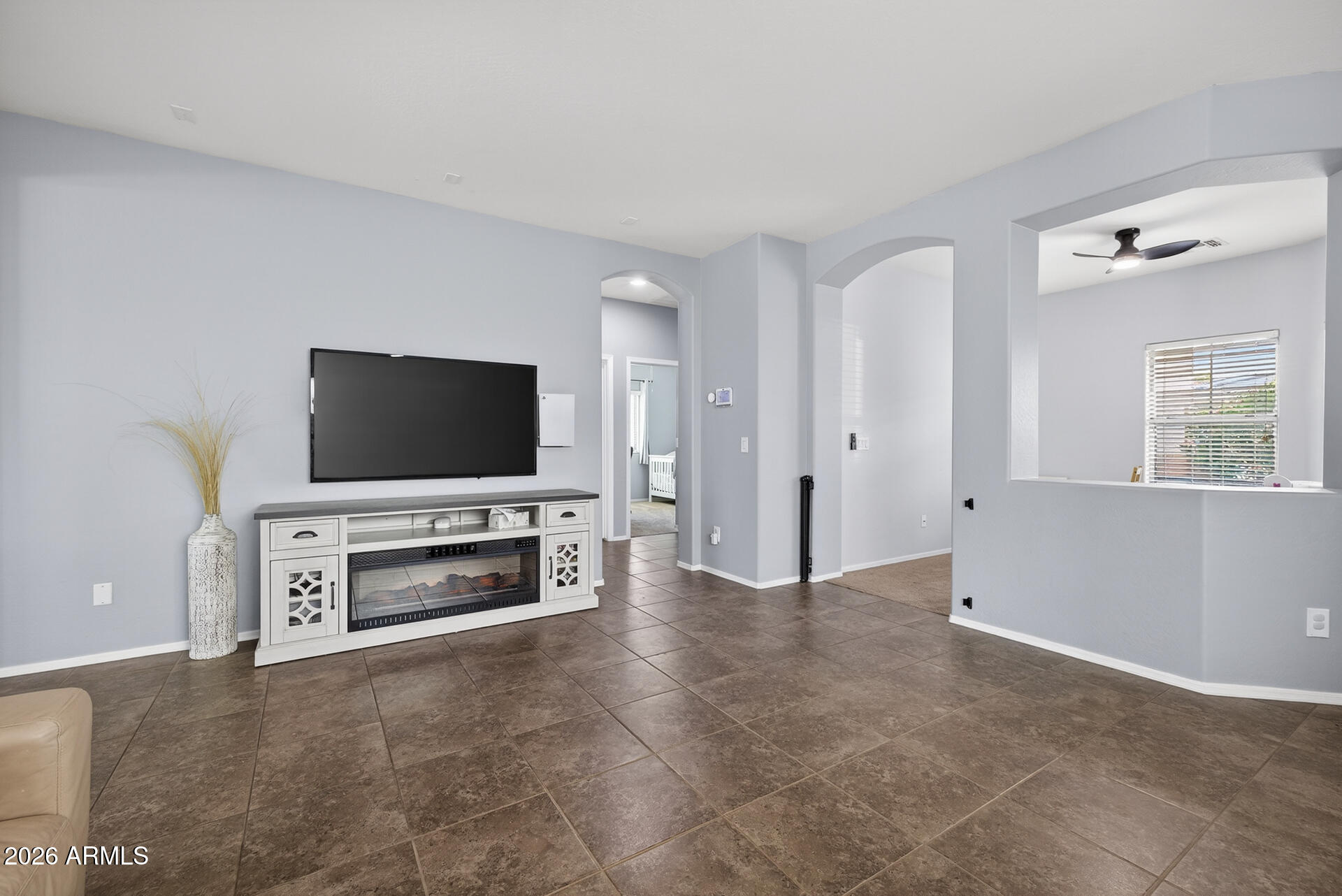 724 West Trellis Road Queen Creek, AZ 85140 - Photo 8 of 46 a living room with furniture and a flat screen tv