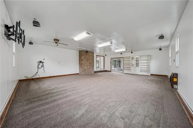 a view of a room with gym equipment and a window