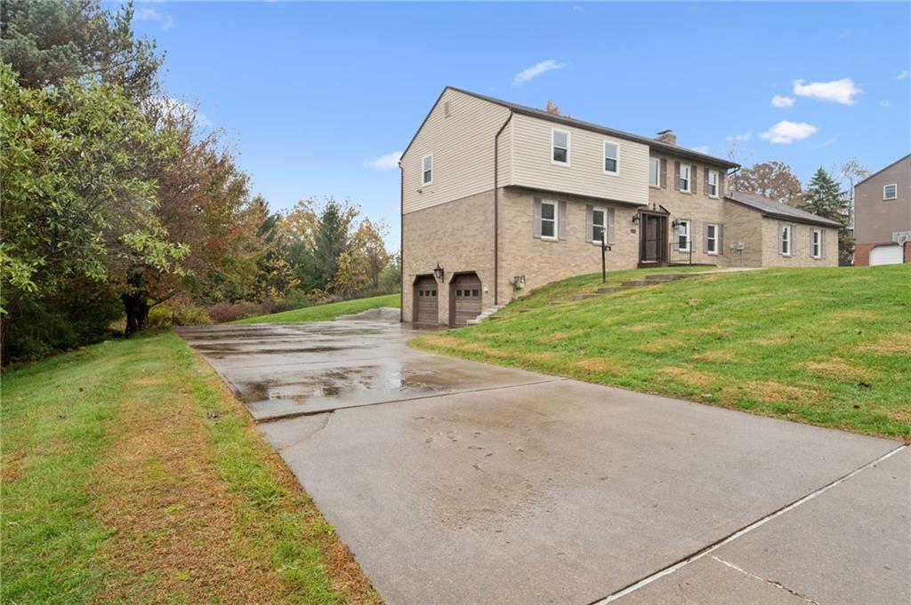 214 Ridgeview Drive Wexford, PA 15090 - Photo 38 of 43 a view of a large white house with a big yard and large trees